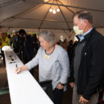 a person signs a steel beam for the student center at Ƶ
