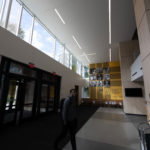 A student in the atrium of the newly-renovated Lowry Center at Ƶ.