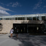 Two students walk outside the front of the Lowry Student Center at Ƶ.