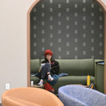 A student studying in the green theme room on the second floor of Lowry Center at Ƶ.